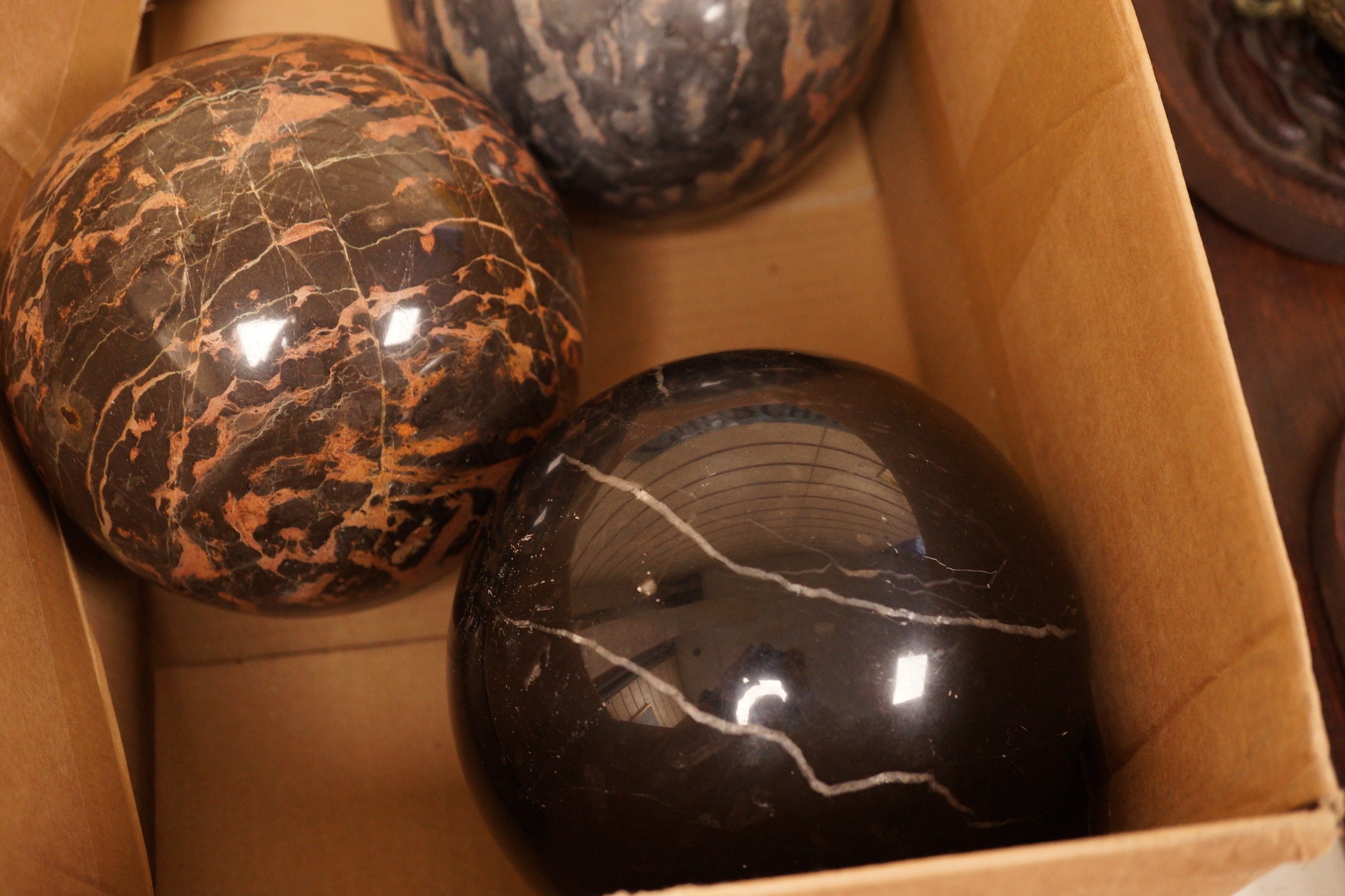 A trio of carved marble balls, largest 14.5cm